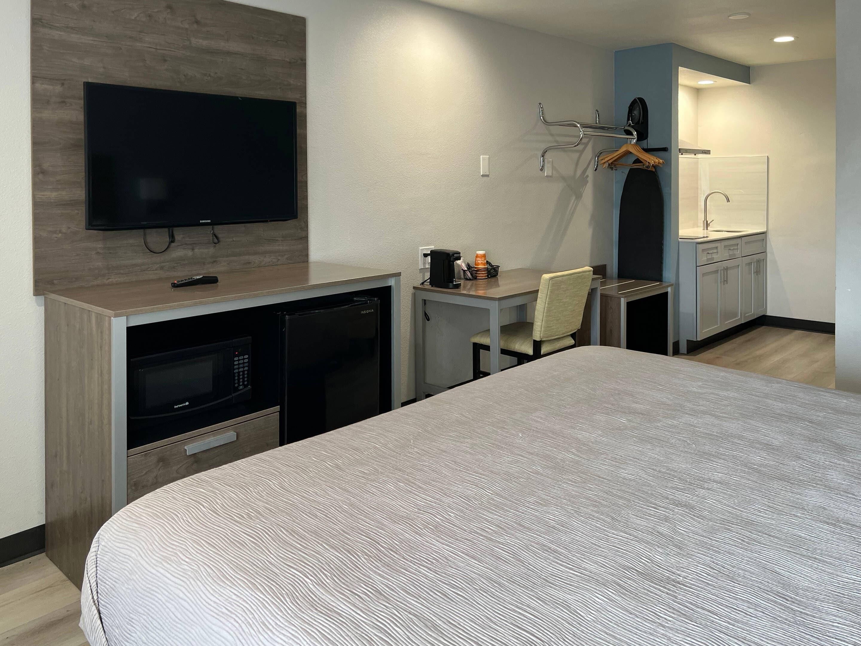 Desk, laptop workspace, blackout curtains, iron/ironing board