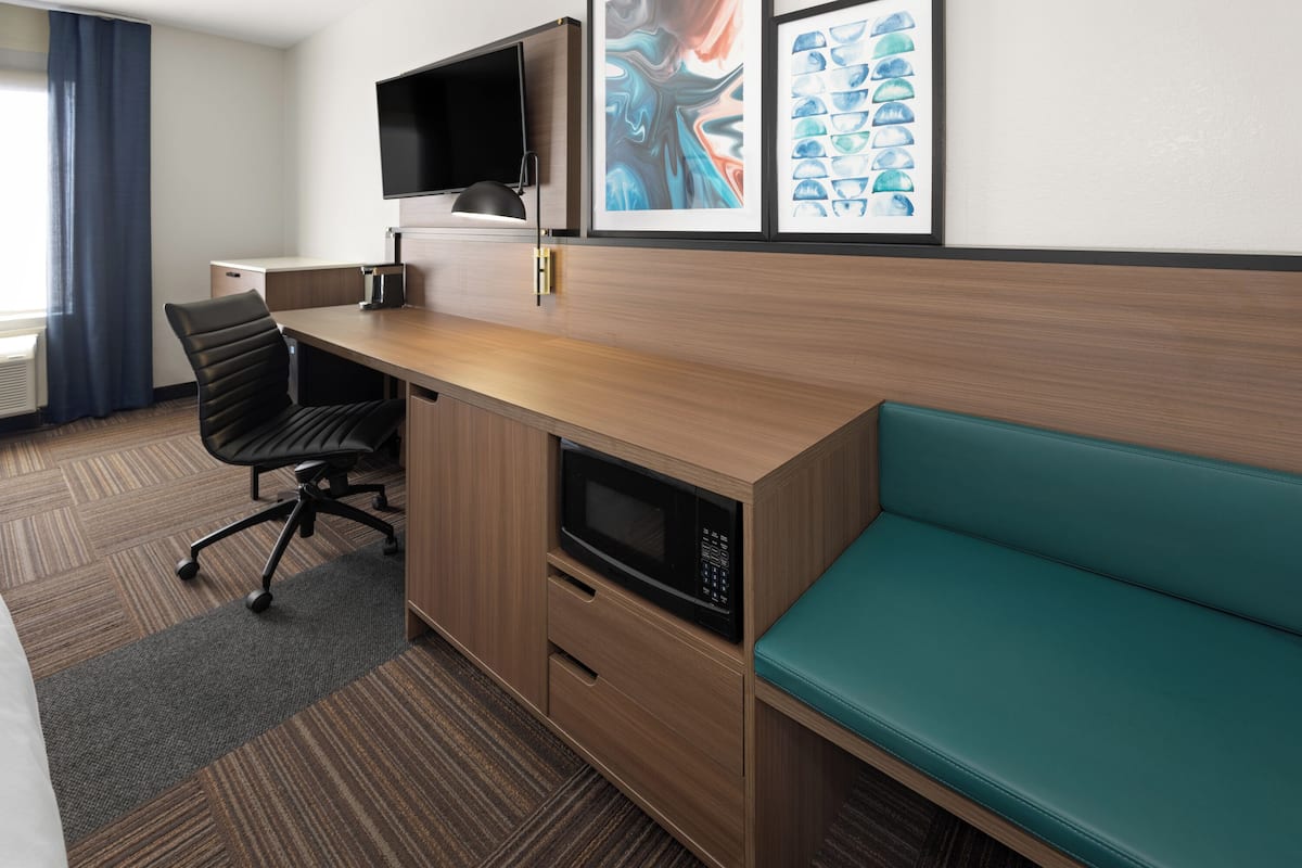 Hypo-allergenic bedding, desk, laptop workspace, blackout drapes