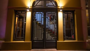 A building entrance with a double door and two windows on either side. - Residence & Spa Le Prince Regent (Paris)