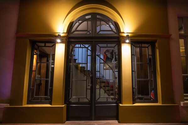 A building entrance with a double door and two windows on either side. - Residence & Spa Le Prince Regent (Paris)