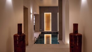 A modern interior with a central pool, minimalist design, and ambient lighting. - Residence & Spa Le Prince Regent (Paris)