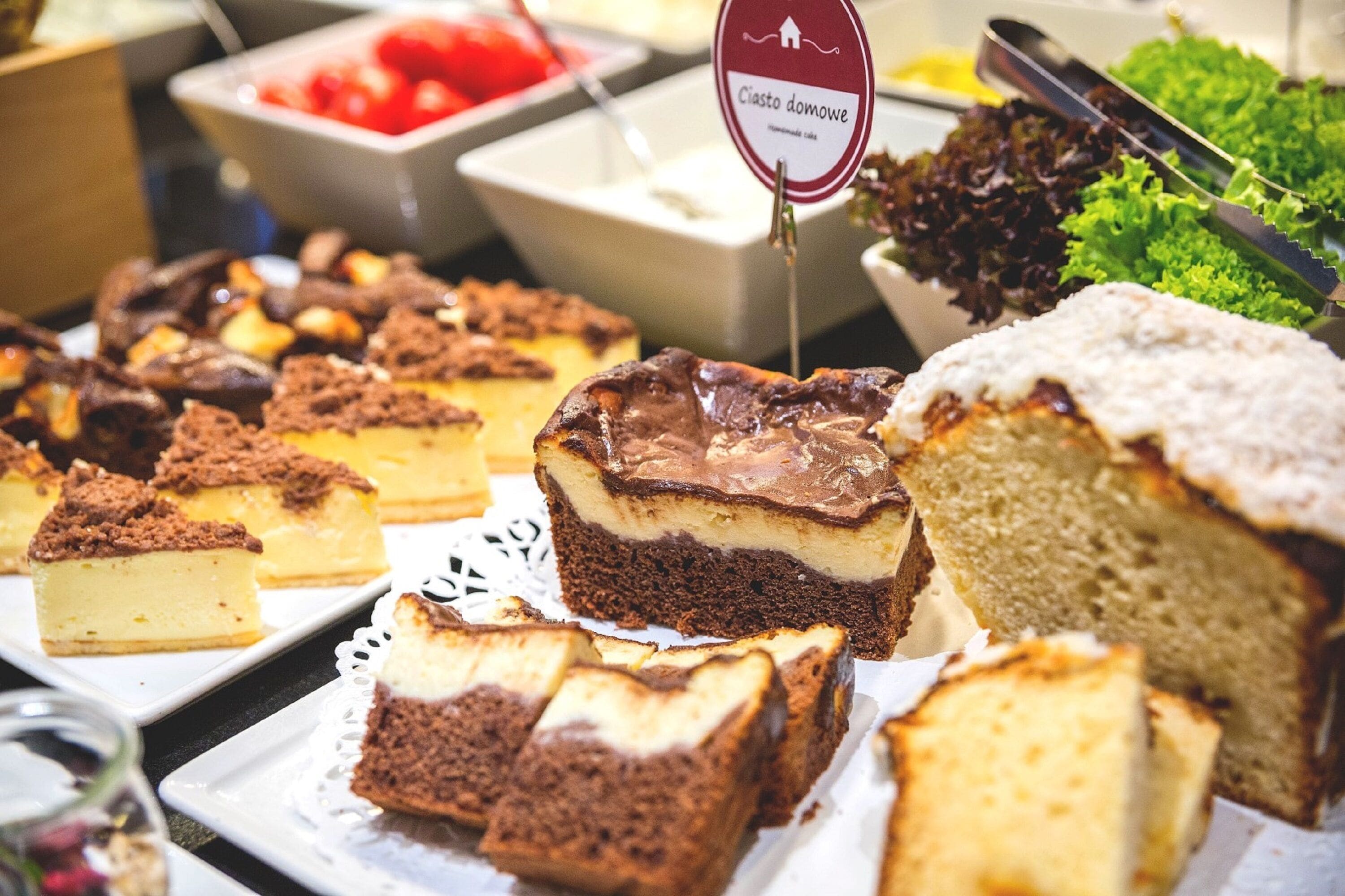 A buffet with various desserts including cakes and pastries.