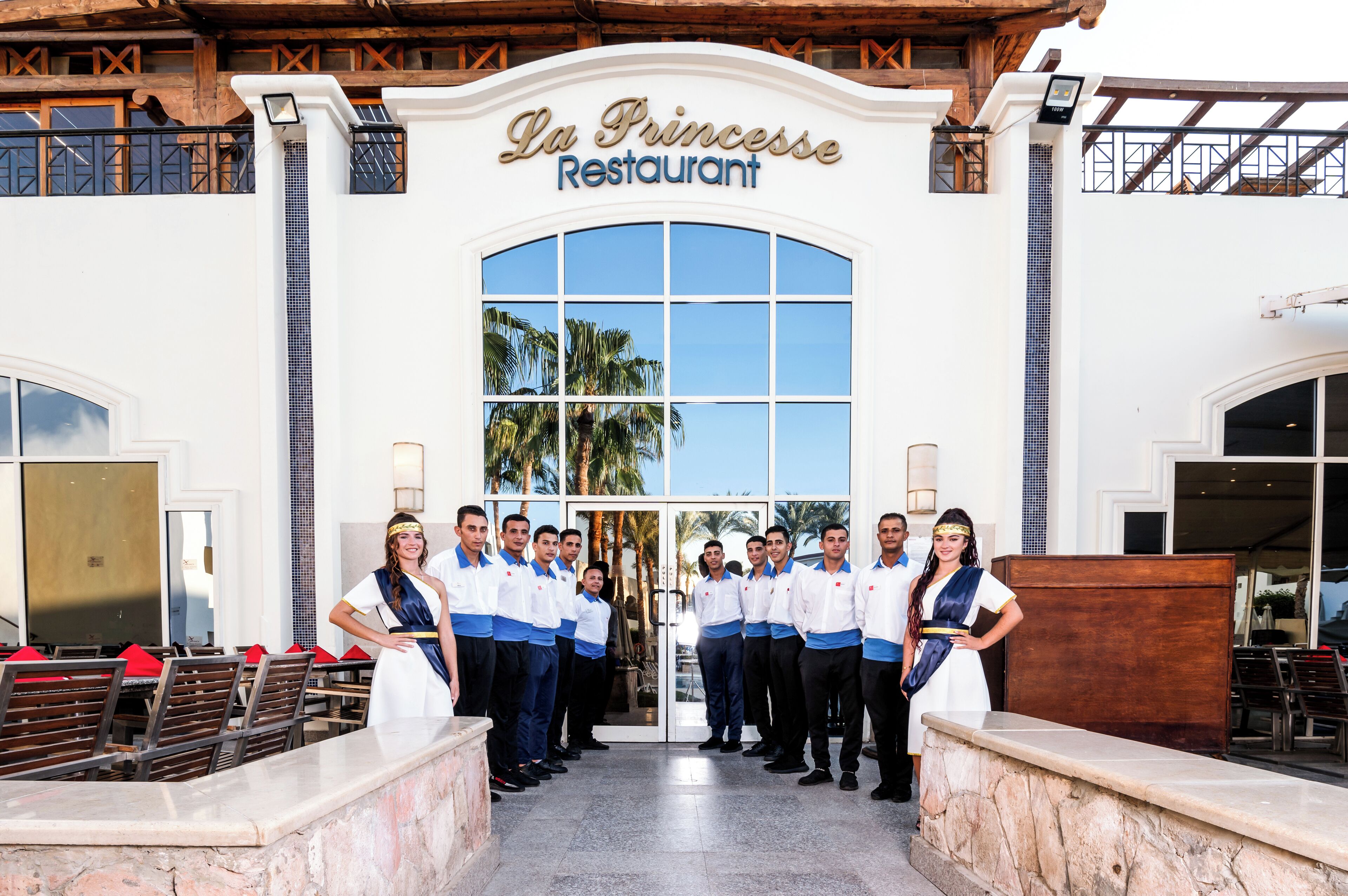 The entrance of La Princesse Restaurant with a group of people standing in front.