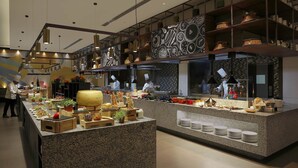 A modern kitchen with granite countertops, stainless steel appliances, and a variety of cooking utensils and ingredients. - Novotel Hyderabad Convention Centre Hotel (Hyderabad)