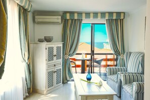 Standard Double Room | Living area | Flat-screen TV