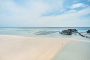 On the beach, white sand, sun loungers, beach umbrellas