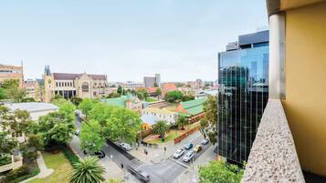 A cityscape with a mix of historic and modern buildings, a prominent church, and a modern glass building.