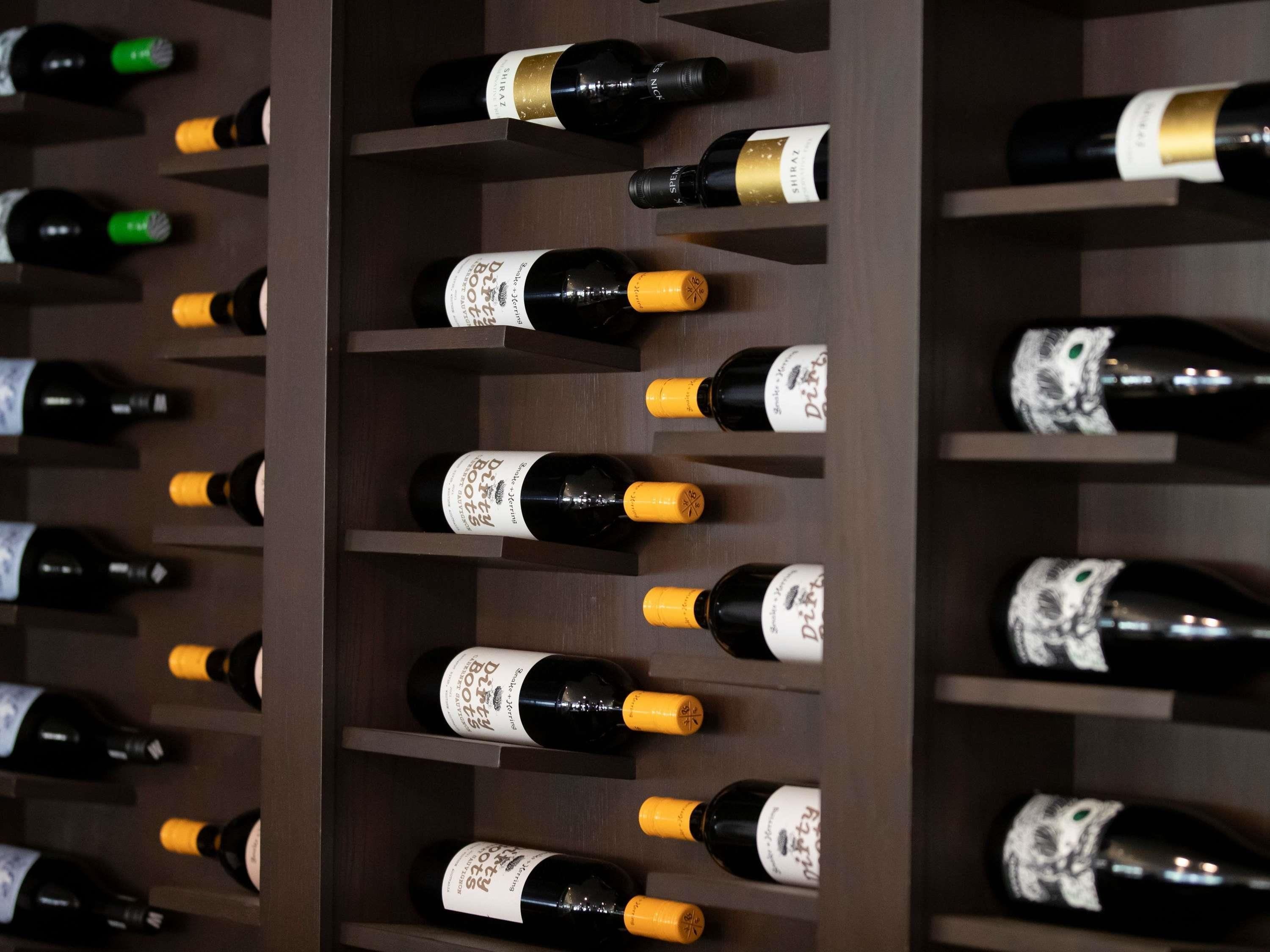 A wine rack with multiple bottles of wine.