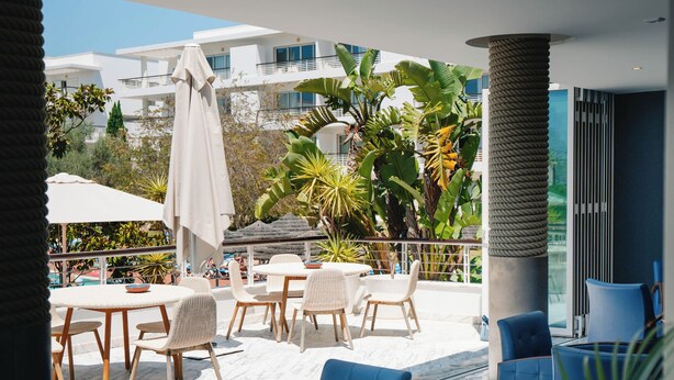 A rooftop terrace with outdoor seating, a pool, and a view of buildings and greenery. - Marina Club Suite Hotel (Lagos)