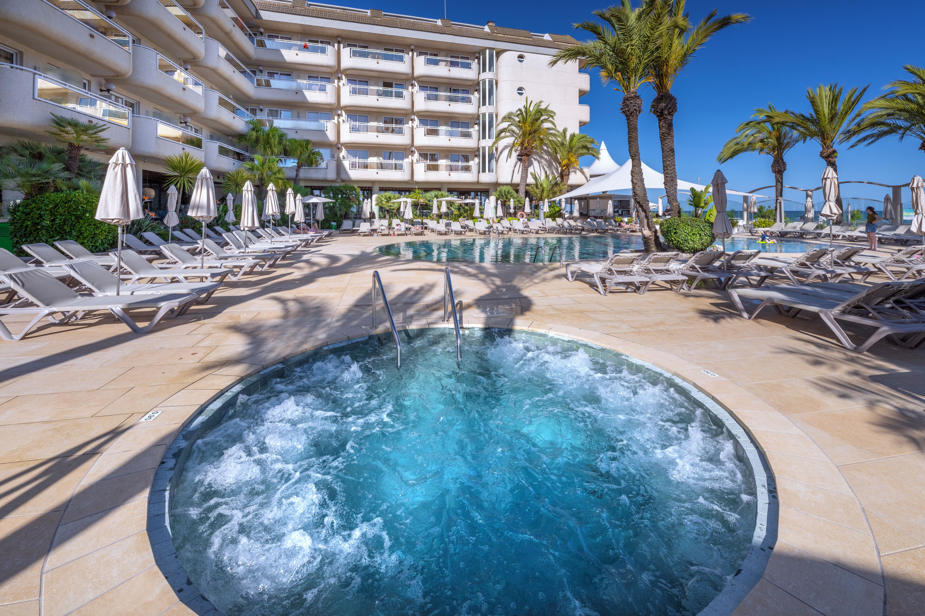 Una piscina cubierta, una piscina al aire libre de temporada, sombrillas