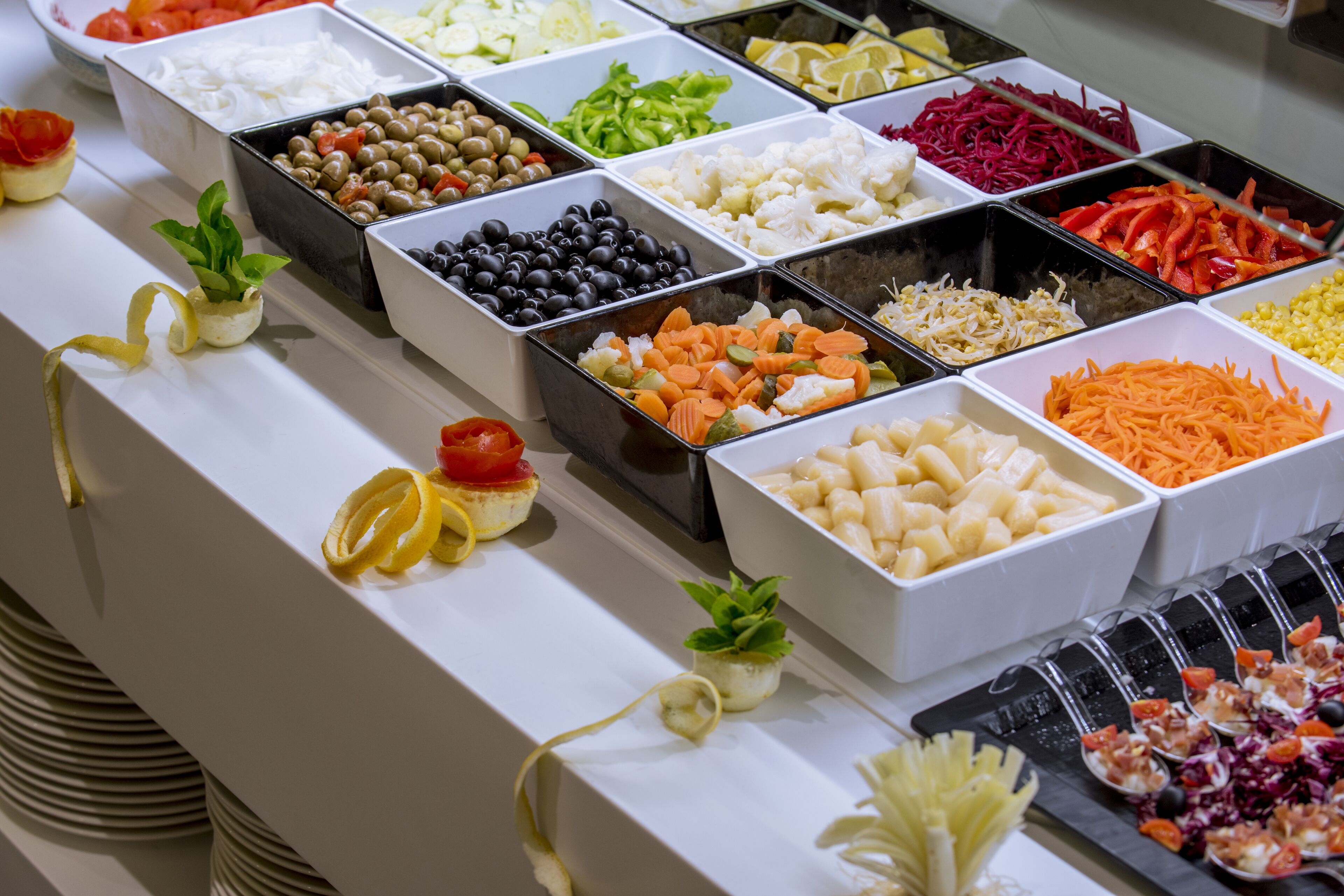 A buffet with various food items in trays.