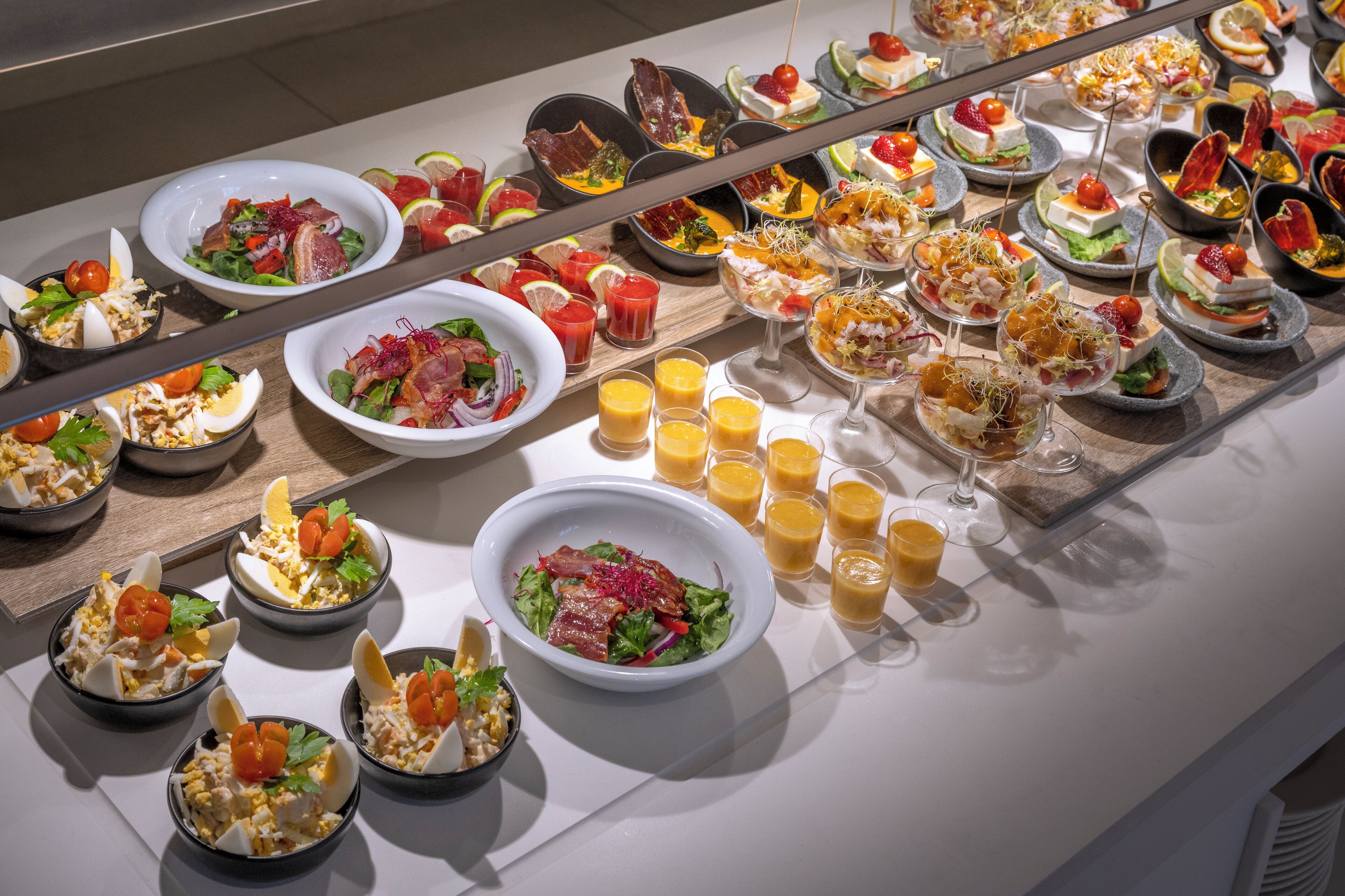 A buffet with various dishes and drinks.