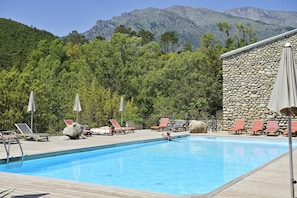 Piscina a l'aire lliure, para-sols i gandules
