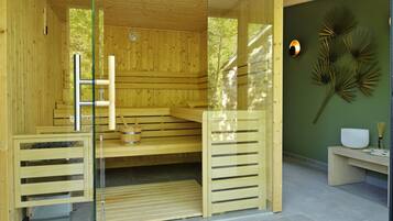 A wooden sauna with glass doors, a bench, and a wall-mounted heater.