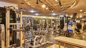 A gym with various exercise equipment, including weight machines and free weights, and mirrors on the walls. - Provista Hotel (Seoul)