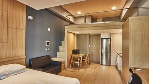 A modern hotel room with a bed, a desk, and a kitchenette. - Provista Hotel (Seoul)
