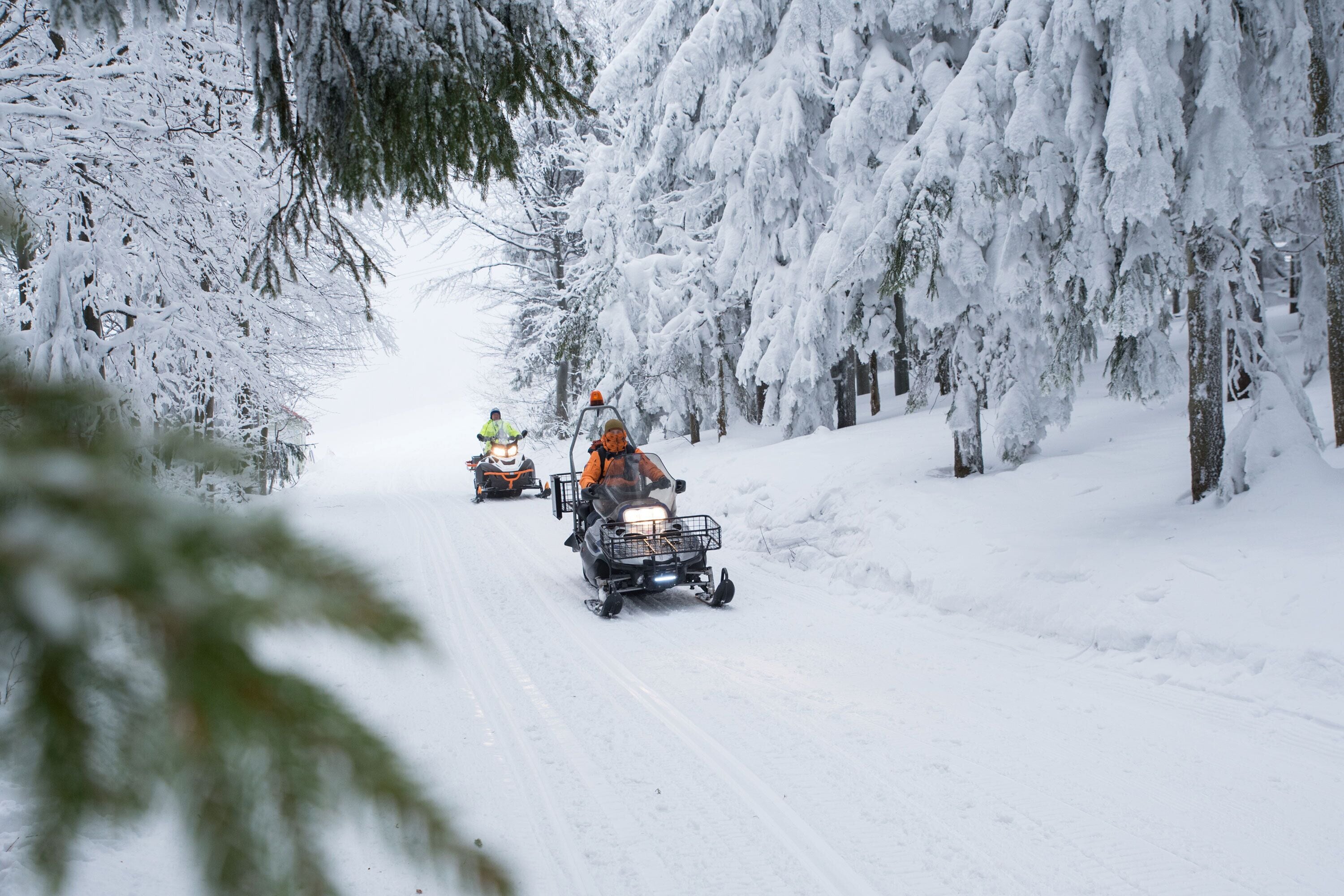 A snow-covered road with vehicles.