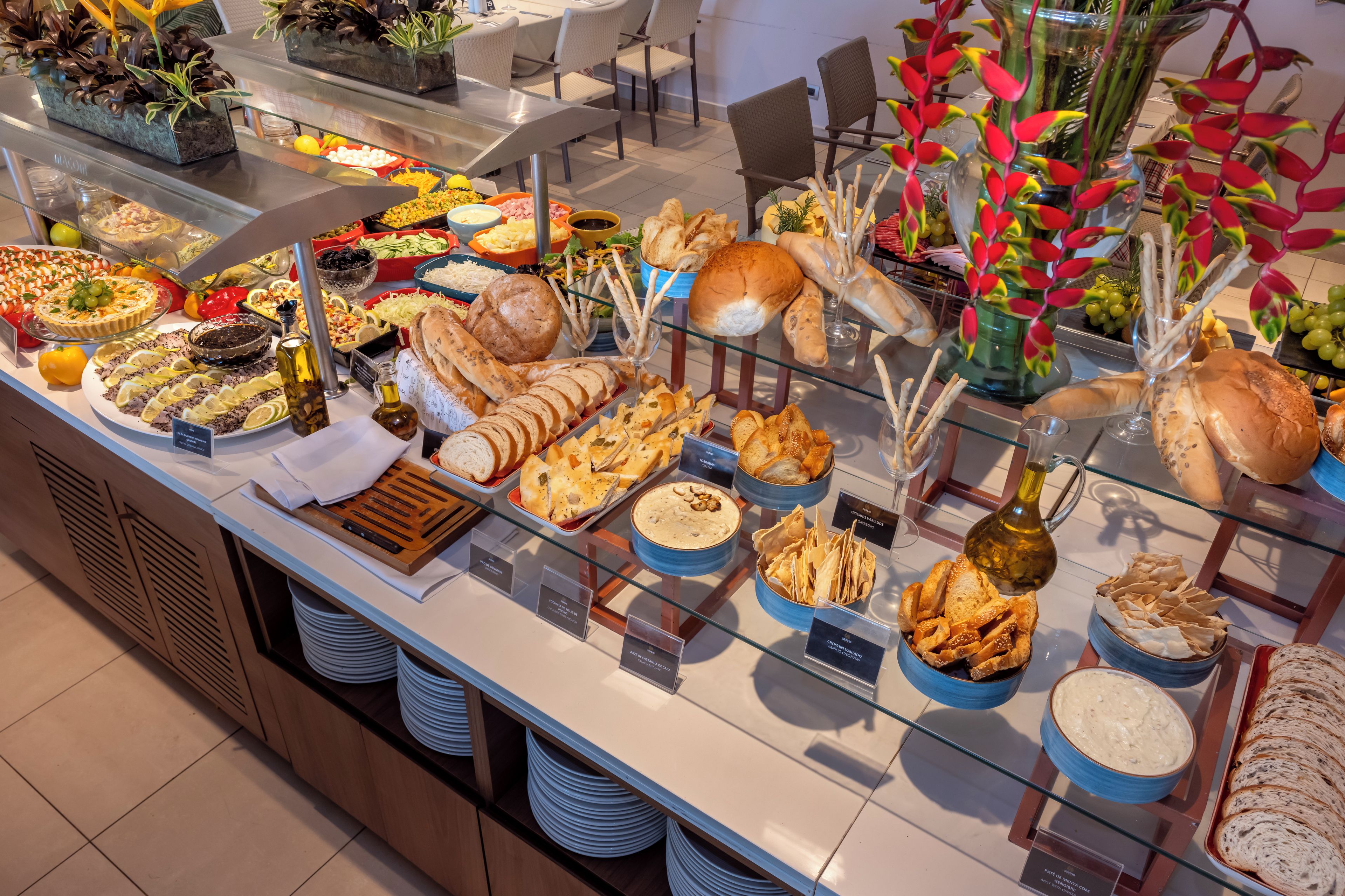 A buffet with various food items and a glass display case.