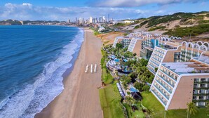 A beachfront hotel with multiple balconies, a swimming pool, and a view of the ocean. - Serhs Natal Grand Hotel & Resort (Natal)