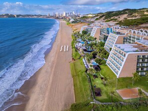 A beachfront hotel with multiple balconies, a swimming pool, and a view of the ocean. - Serhs Natal Grand Hotel & Resort (Natal)