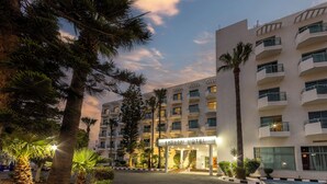 A multi-story hotel with a sign reading "ANTIGONI HOTEL" at the entrance. - Antigoni Hotel (Paralimni)