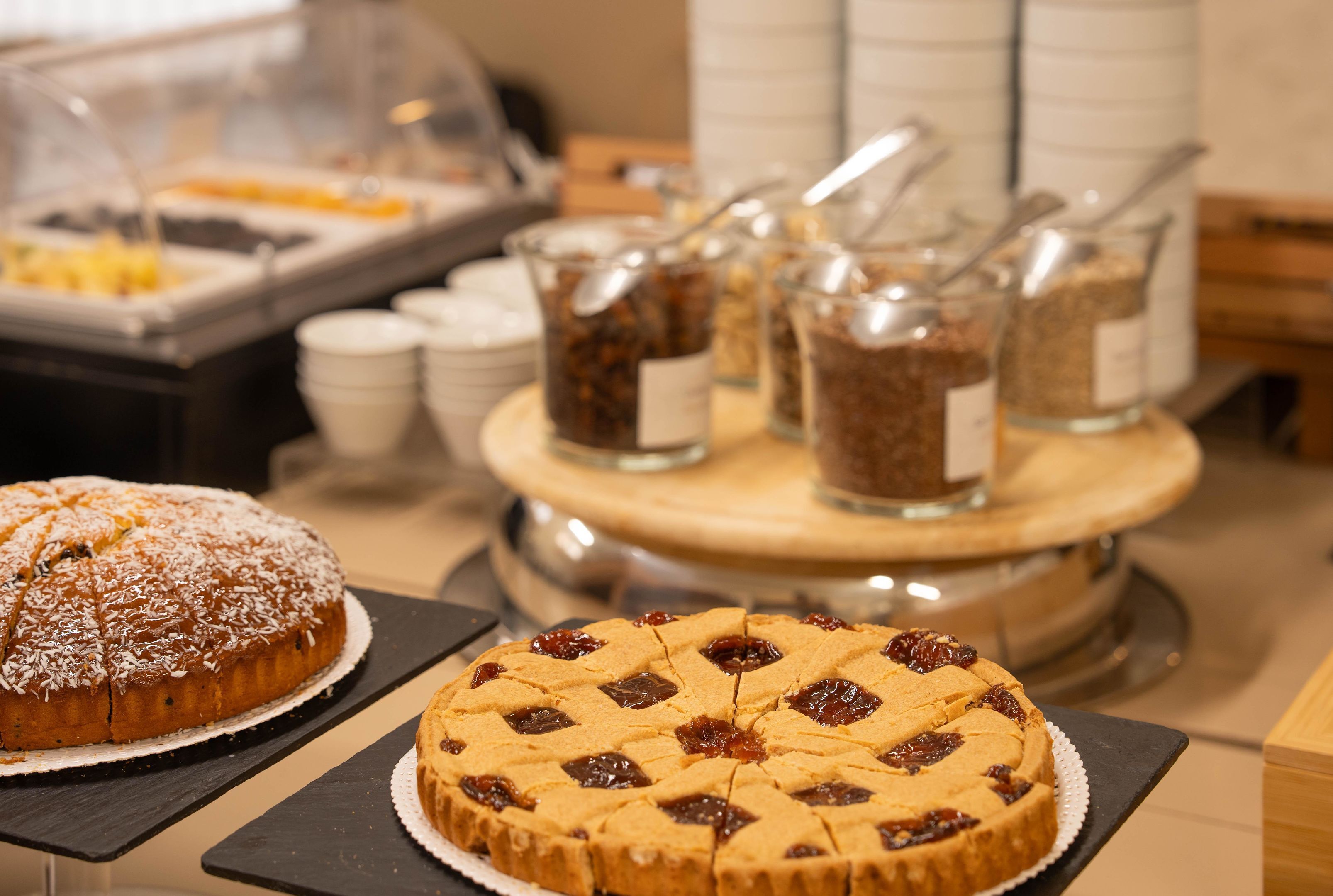 A buffet with various food items and containers.