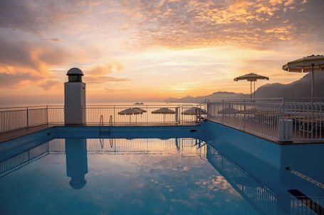 Seasonal outdoor pool, open 9:00 AM to 8:00 PM, pool umbrellas