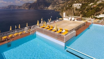 Seasonal outdoor pool, open 9:00 AM to 8:00 PM, pool umbrellas