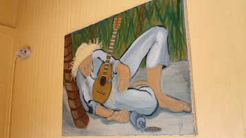 A painting of a person lying on the floor with a guitar.