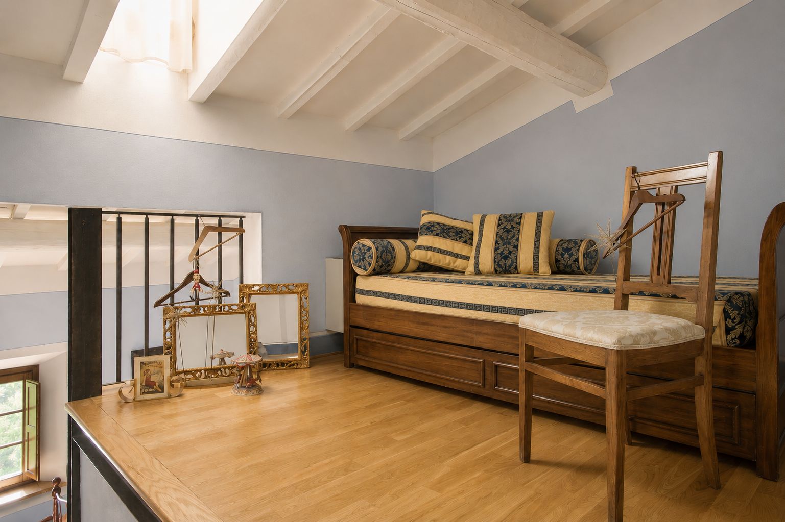 A bedroom with a wooden bed, a wooden chair, and a wooden table.
