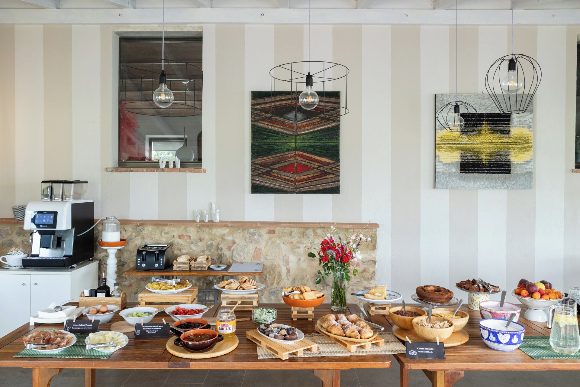 A breakfast buffet with various food items and a coffee machine.