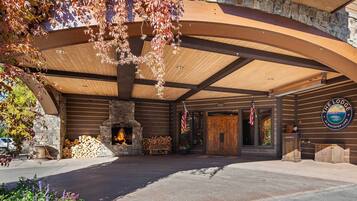A lodge with a stone facade, wooden beams, and a fireplace.