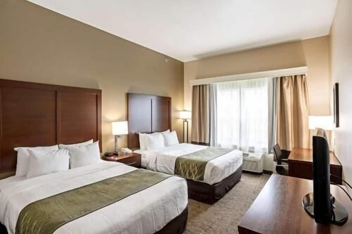 Premium bedding, desk, laptop workspace, blackout drapes