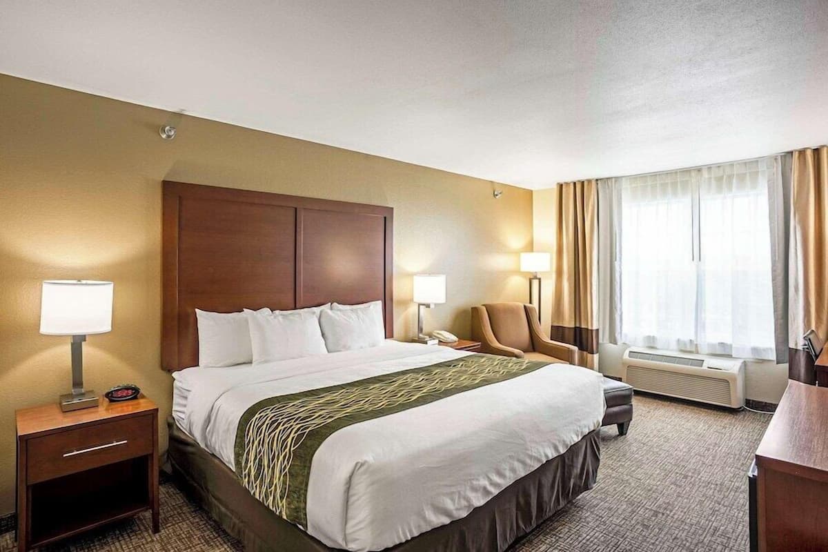 Premium bedding, desk, laptop workspace, blackout drapes
