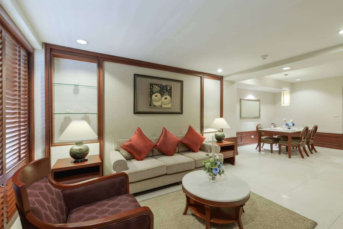 A modern living room with a sofa, a dining table, and a coffee table.