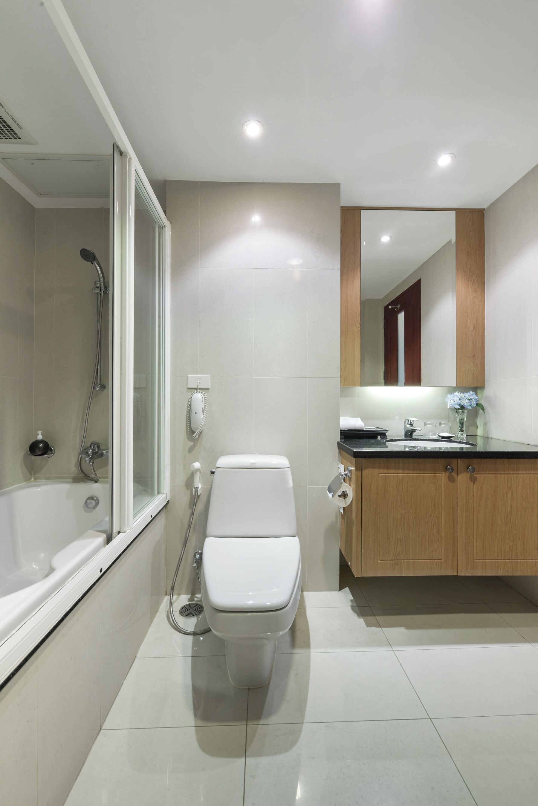 A modern bathroom with a bathtub, toilet, and sink.