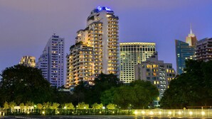 A high-rise hotel with multiple floors, illuminated windows, and a prominent sign at the top. - Centre Point Sukhumvit 10 (Bangkok)