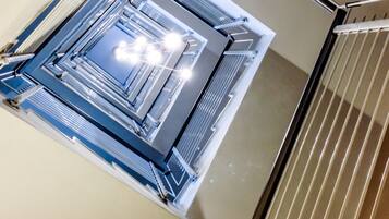 A high-tech, industrial-style interior with metallic structures and lighting fixtures.