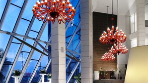 A modern lobby with a high ceiling, large windows, and contemporary furniture. - Antony Palace Hotel (Marcon)