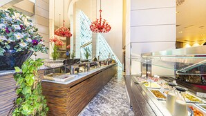 A modern hotel lobby with a reception desk, a glass railing, and a buffet area. - Antony Palace Hotel (Marcon)