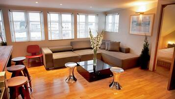Deluxe Penthouse, 2 Bedrooms | Living room | Flat-screen TV, video-game console, DVD player