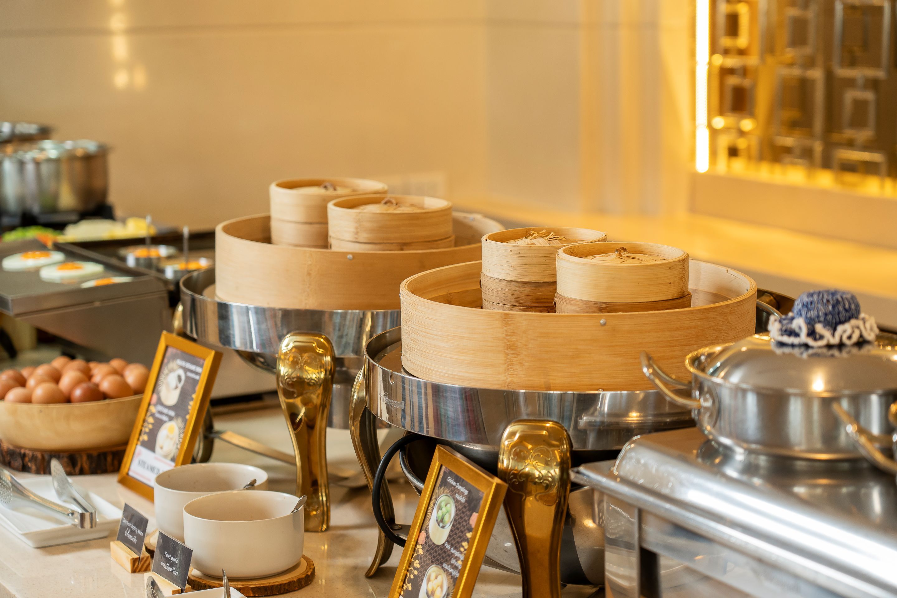 A buffet setup with various food items and utensils.