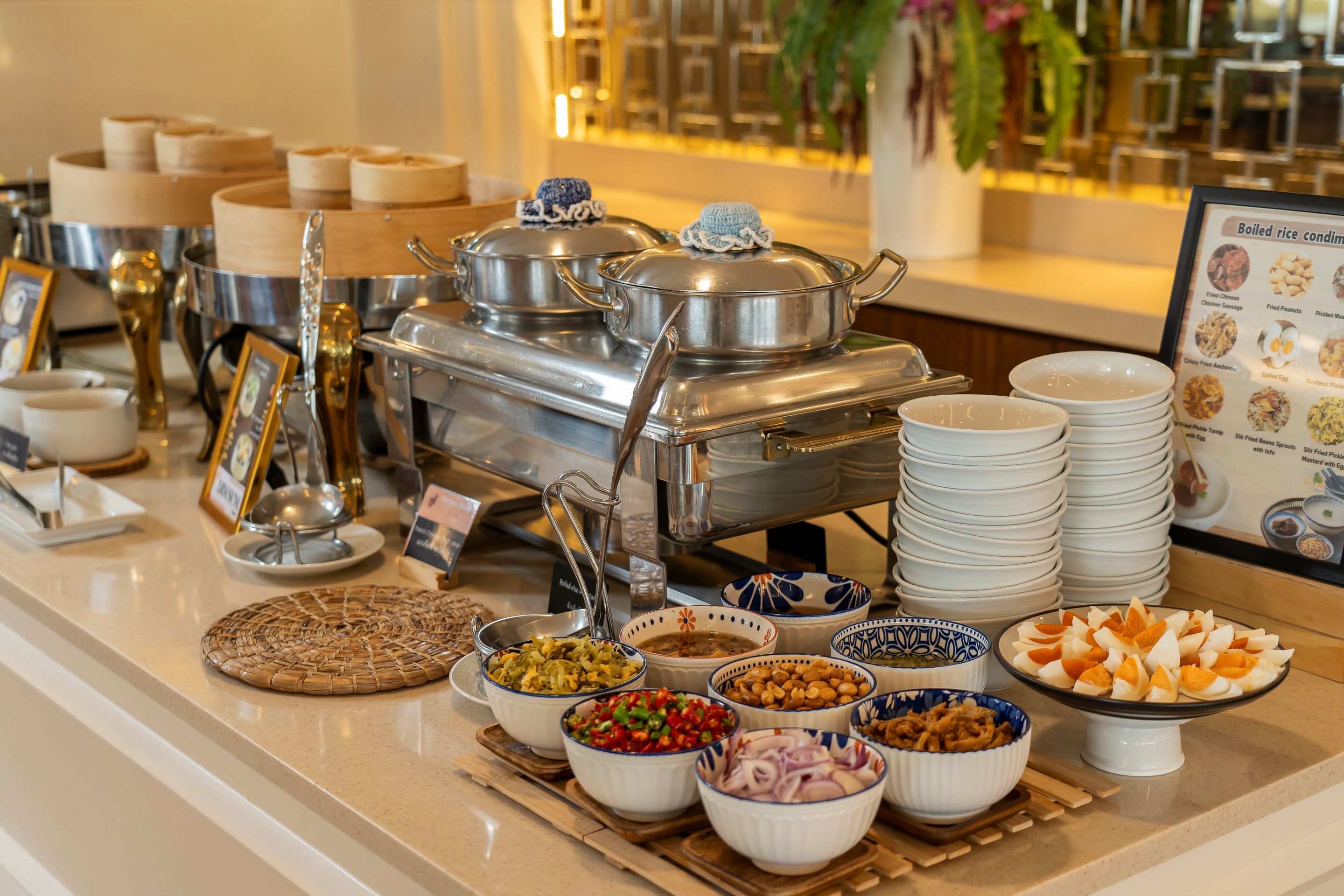 A buffet setup with various food items and serving utensils.