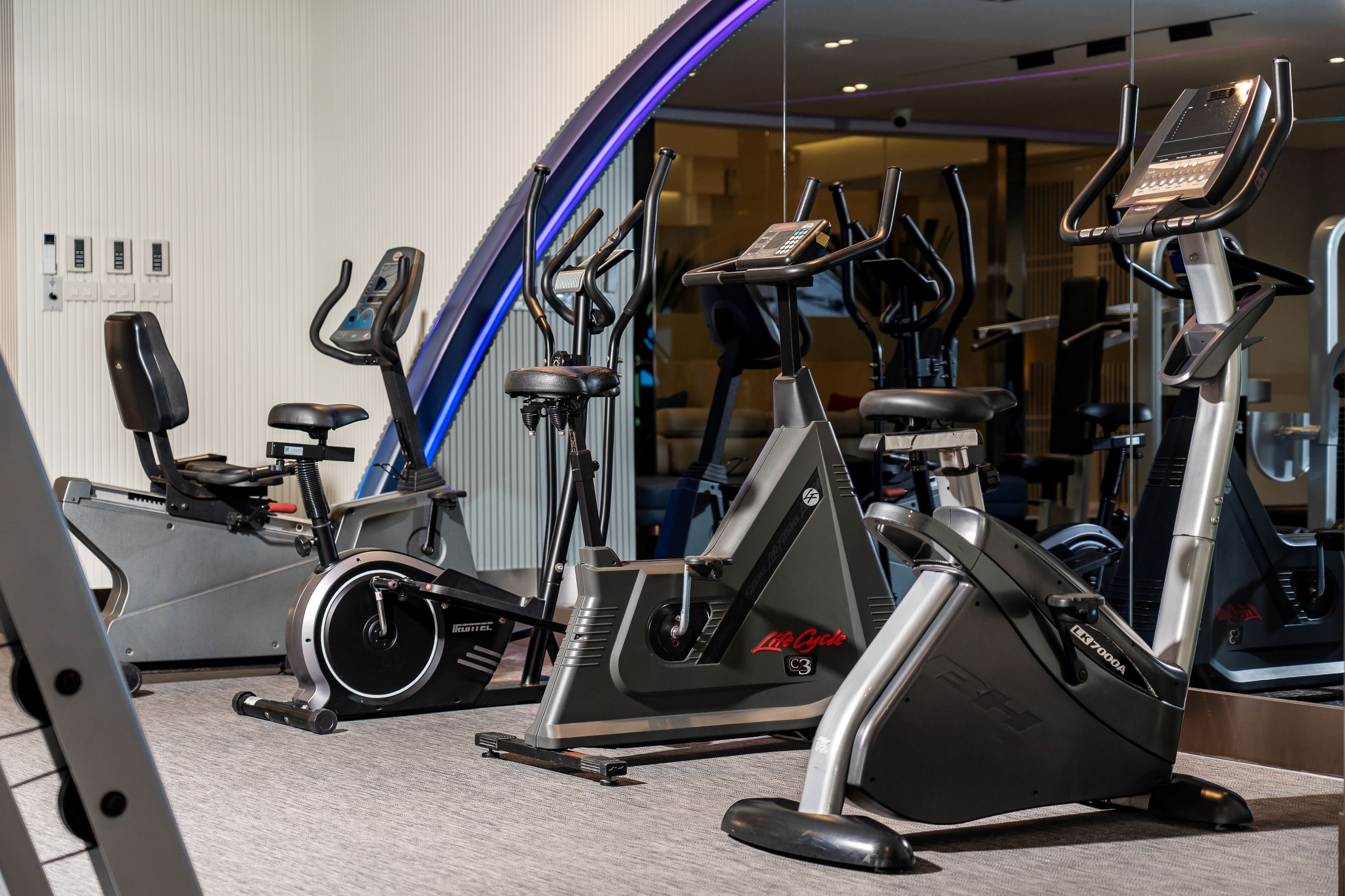 A gym with stationary bikes and cardio equipment.