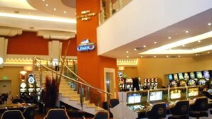 A casino with slot machines and a sign for 'JUMBO'.