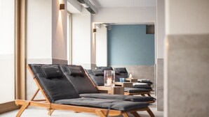 A modern spa area with lounge chairs and a mirror reflecting the room. - Landhotel Saarschleife (Mettlach)