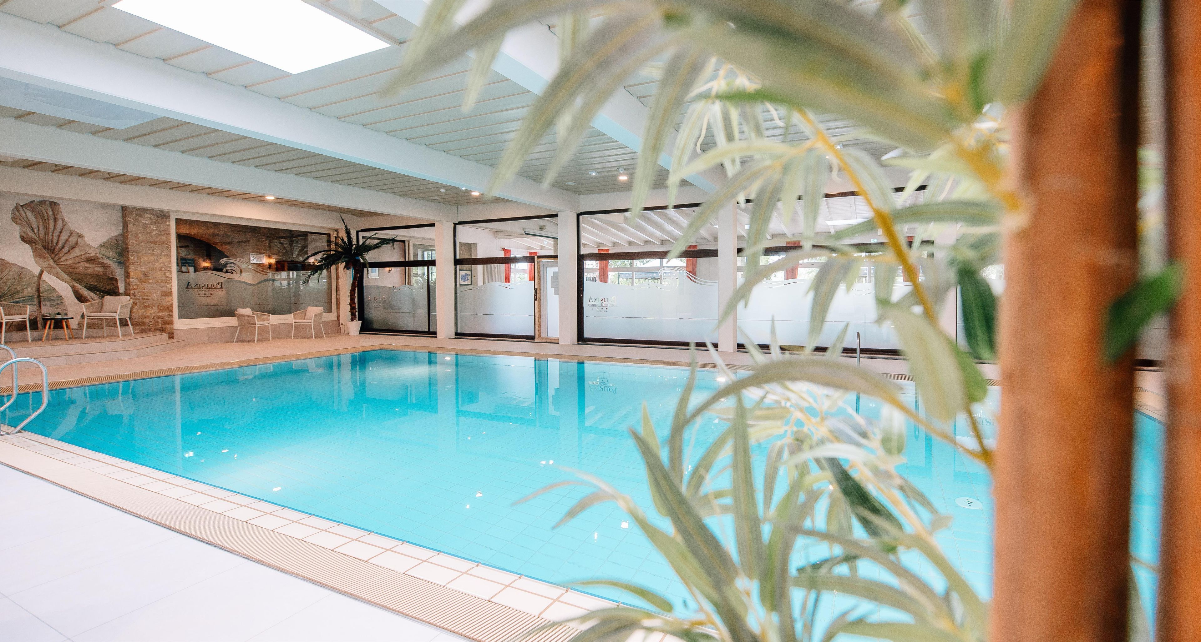 Indoor pool, open 7:00 AM to 10:00 PM, pool loungers
