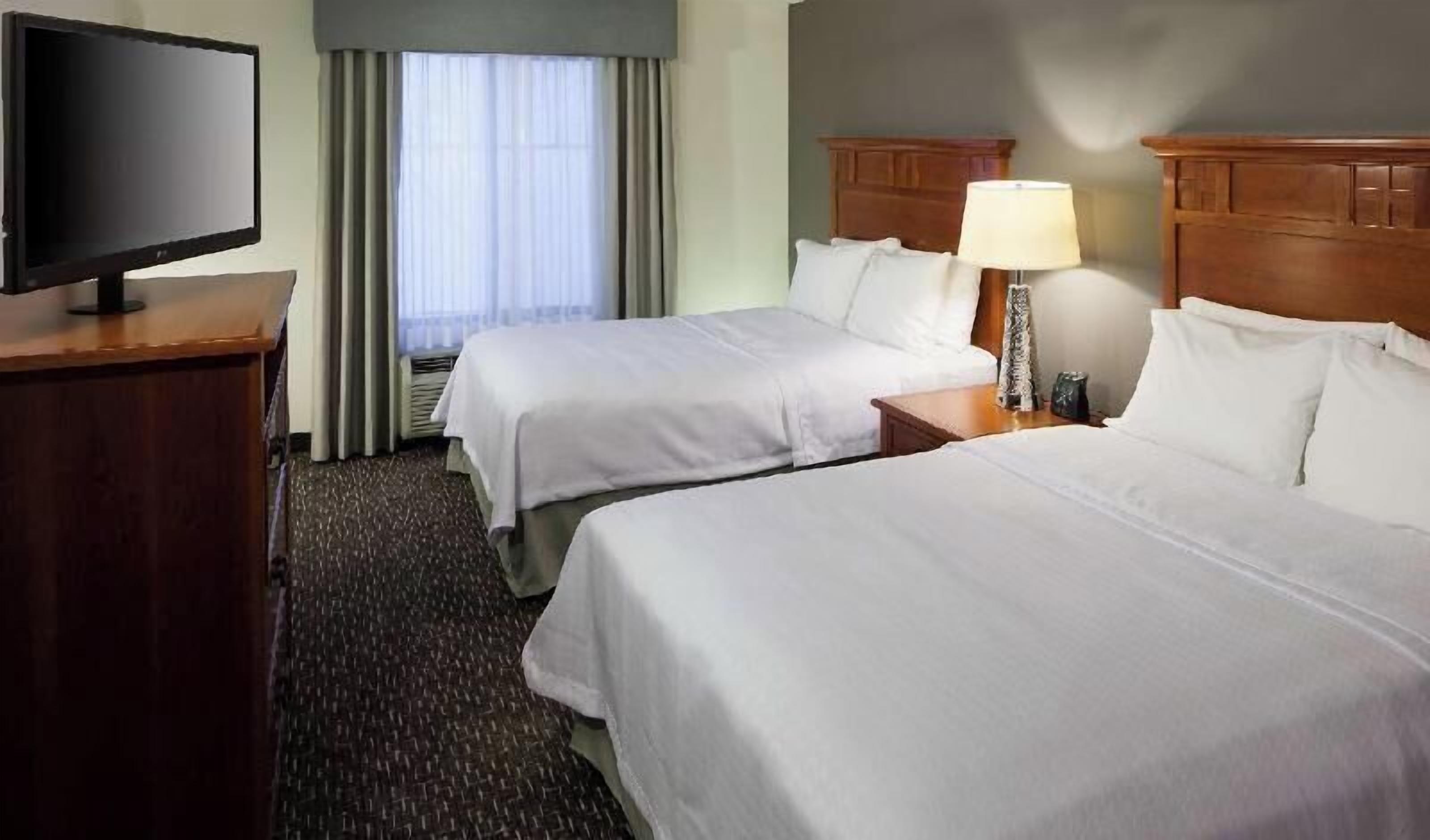 Premium bedding, desk, laptop workspace, blackout drapes