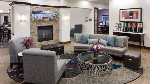 A modern lounge area with a fireplace, seating, and a coffee station. - Homewood Suites by Hilton Agoura Hills (Agoura Hills)