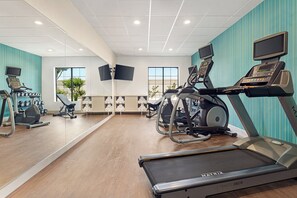 A gym with treadmills, stationary bikes, and weight machines. - Holiday Inn Express & Suites Shawnee by IHG (Shawnee)